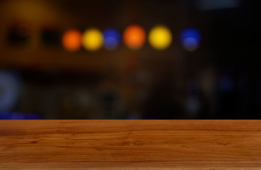 Empty dark wooden table in front of abstract blurred background of cafe and coffee shop interior. can be used for display or montage your products - Image.