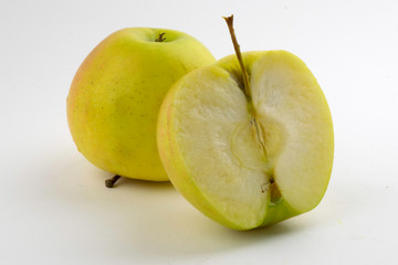 whole and sliced apples on a white background