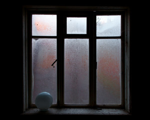 a lighted window in the black room of an abandoned house, a clear outline, glass covered with frost,