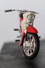 Fototapeta premium Veteran red plastic motorbike on a stand.