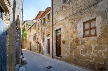 Fototapeta na wymiar Historic buildings and empty street at Pitigliano fortress.