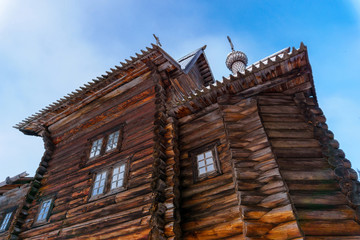 fragment of old wooden church against the sky