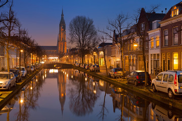 Fototapeta na wymiar Church reflected in a canal in Delft, The Netherlands