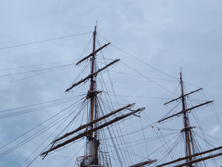 Masts and the rigging of ancient sailboat on nignt sky background. Exterior of old tall ship. Amerigo Vespucci - bow of ancient sailing vessel.
