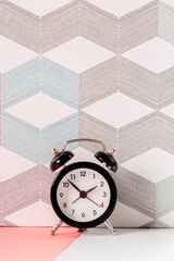 Vintage background with retro alarm clock on table