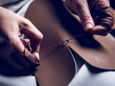 Crop hands stitching leather for shoes