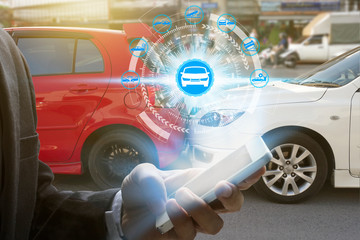 Hand use smartphone with car claim icons over the Network connection on car crash background, car...