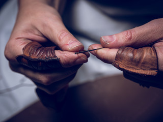 Crop hands preparing needle and thread