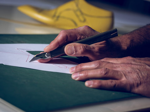 Crop hands cutting shoe template