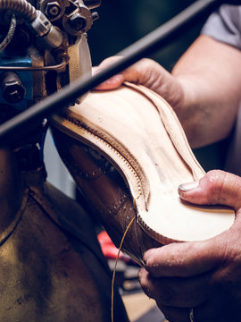 Crop craftsman making shoe on factory