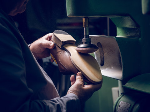 Crop craftsman making shoe on factory