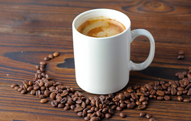 A cup of coffee on a wooden table.