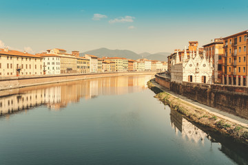 Fototapeta na wymiar Famous small Santa Maria della Spina Church in Pisa on a bank of Arno river