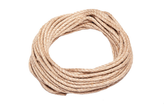 Closeup of rough brown braided rope coiled in the form of ring. Concept equipment, strength, sport, fitness, exercise, workout, strong, training, cord, lifestyle, athlete, activity young people
