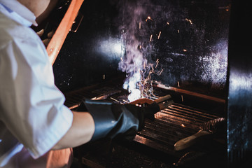 Thai Engineering student perform electric metal welding in workshop class with a lots of spark.