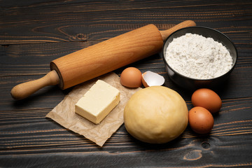 unrolled and unbaked Shortcrust pastry dough recipe on wooden background
