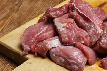 Pieces of fresh and juicy meat on the cutting Board