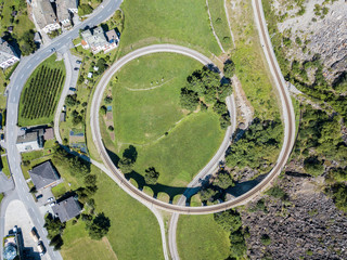Aerial or drone photography of the circular viaduct - the famous spiral viaduct in Swiss Alps...
