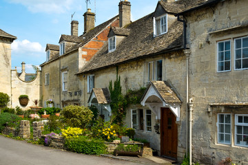Fototapeta na wymiar Many picturesque old Cotswold stone houses line the streets in Painswick, Gloucestershire, UK