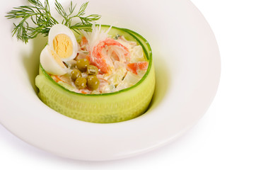Salad Olivier closeup with eggs and a cucumber