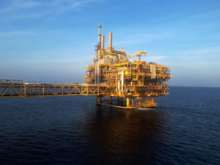 Oil platform in the sea at sunrise