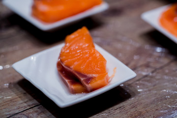 Selective focus to Salmon Sashimi fillet in a small dish