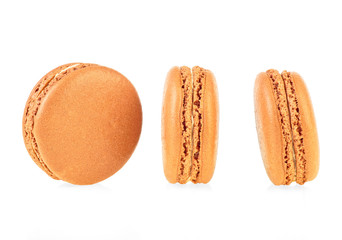 Three tasty brown macaroons isolated on white background