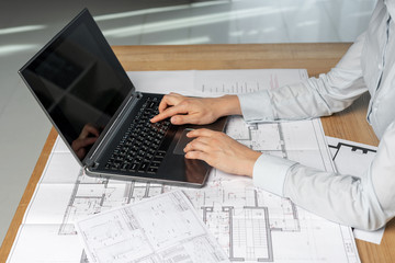 Profile side view photo of cropped confident focused lady in her formalwear shirt she sit at the desk in workplace typing at keyboard pc gadget