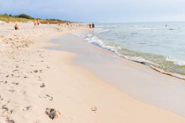 Tourists relax in the sea and on the sandy beach
