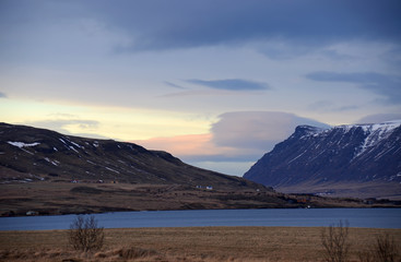 Cold winter morning on the road No. 1 in Iceland amid Mountains in snow caps and blue sky