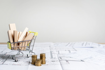 How much it cost? Little shopping cart full of sawmill construction materials standing on table...