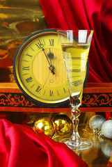 Two glasses of champagne and old clock