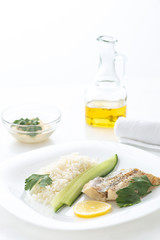 fish steak with rice, lemon and cucumber