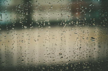 Naklejka na ściany i meble Background and wallpaper by rainy drop and water drops on window glass.