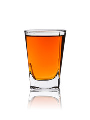 A shot of whiskey or rum with reflection on a white background