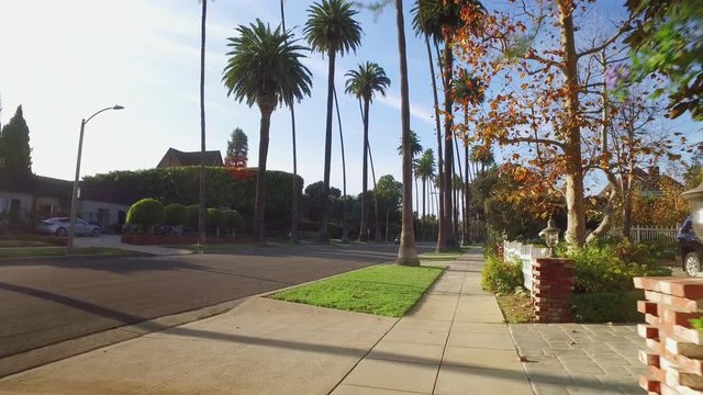 A pedestrian's walking perspective on the streets of a typical Beverly Hills upscale residential neighborhood.  	