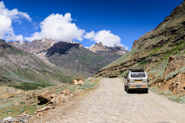 A car travel along the  road on Manali-Leh highway in  Ladakh, Himachal Pradesh, India