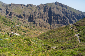 Fototapeta na wymiar View of the Macizo de Teno mountains, Masca Gorge and mountain road to the village of Maska. Tenerife. Canary Islands. Spain. View from the viewpoint - Mirador de La Cruz de Hilda.