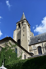 Fototapeta na wymiar Saint Germain des Pres Abbey, Paris, France. Tower with ivy, sunny day, blue sky.