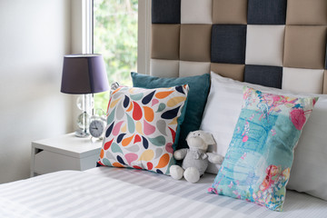 modern bedroom with many pillows on bed
