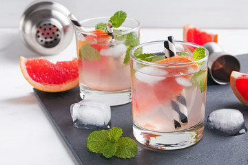 Two glasses of grapefruit cocktail with mint close-up