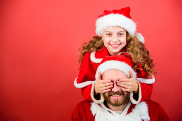 My dad is santa claus. Belief in santa constitutes most magical part of childhood. Guess who. Surprise concept. Girl child and bearded father wear santa costume. How to be santa claus parents guide