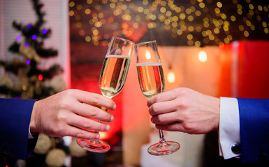 Cheers concept. New year corporate party. Party with champagne. Lets celebrate. Successful year. Drink champagne at party. Colleagues celebrate new year. Male hands formal suit hold champagne glasses