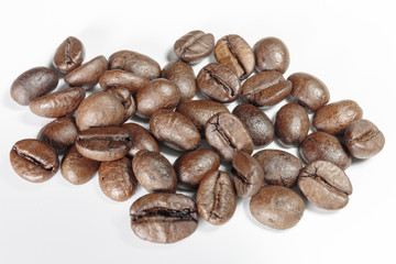 Well-stocked coffee beans on a white background close-up.