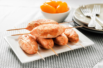 Minced turkey kebabs on square white plate