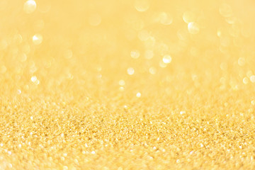 Defocused gold glitter background. Gold abstract bokeh background. Christmas abstract background