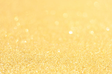 Obraz premium Defocused gold glitter background. Gold abstract bokeh background. Christmas abstract background