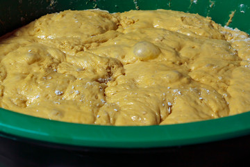 Container with uncooked dough for traditional christmas dessert in Portugal called filhó