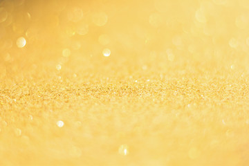 Defocused gold glitter background. Gold abstract bokeh background. Christmas abstract background