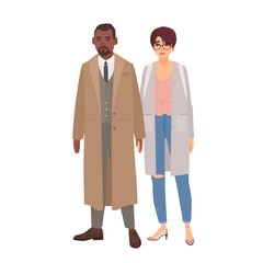 Smiling man and woman dressed in coats standing together